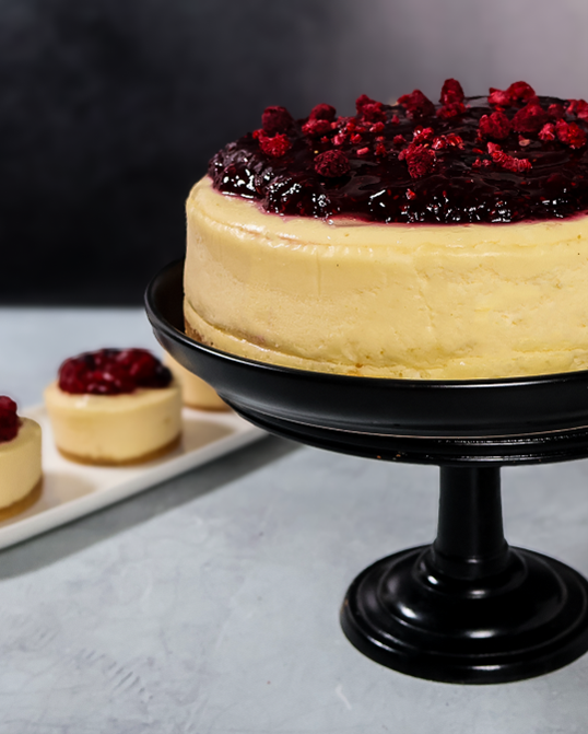 White layered cake topped with fresh berries